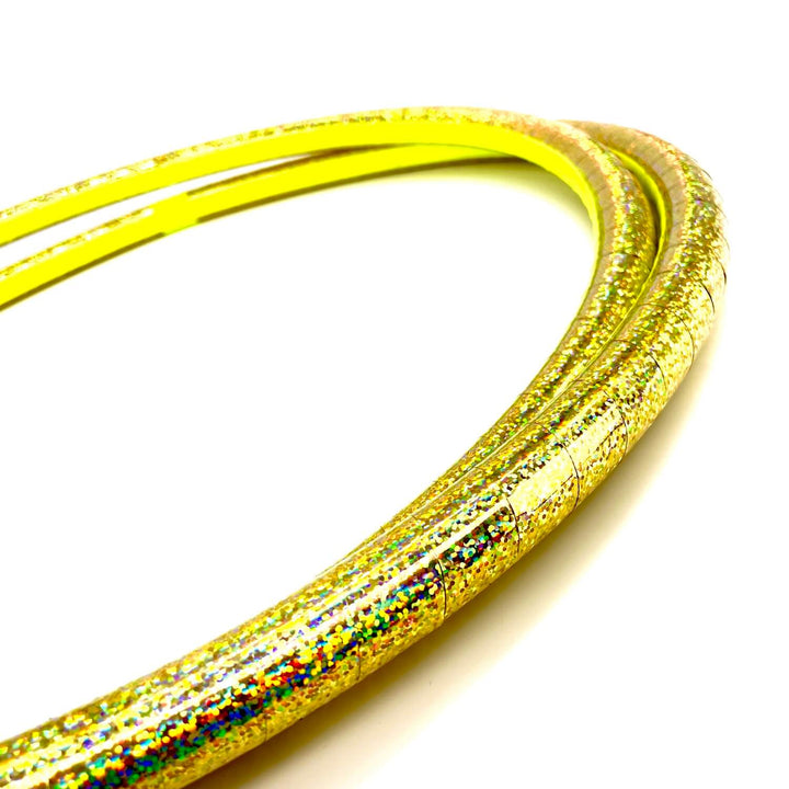 Gold holographic shiny travel hula hoop against a white background