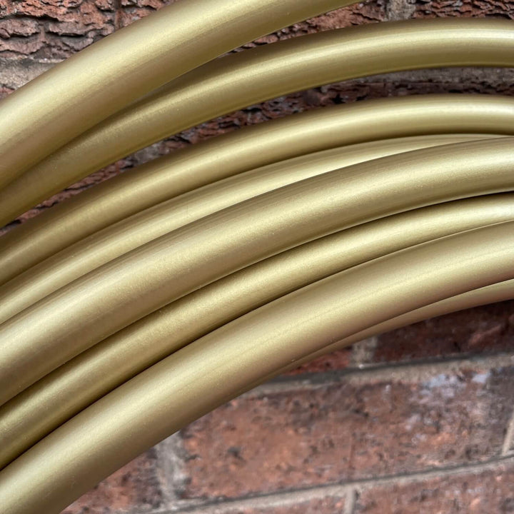 Champagne Gold polypro hoop resting on brick wall