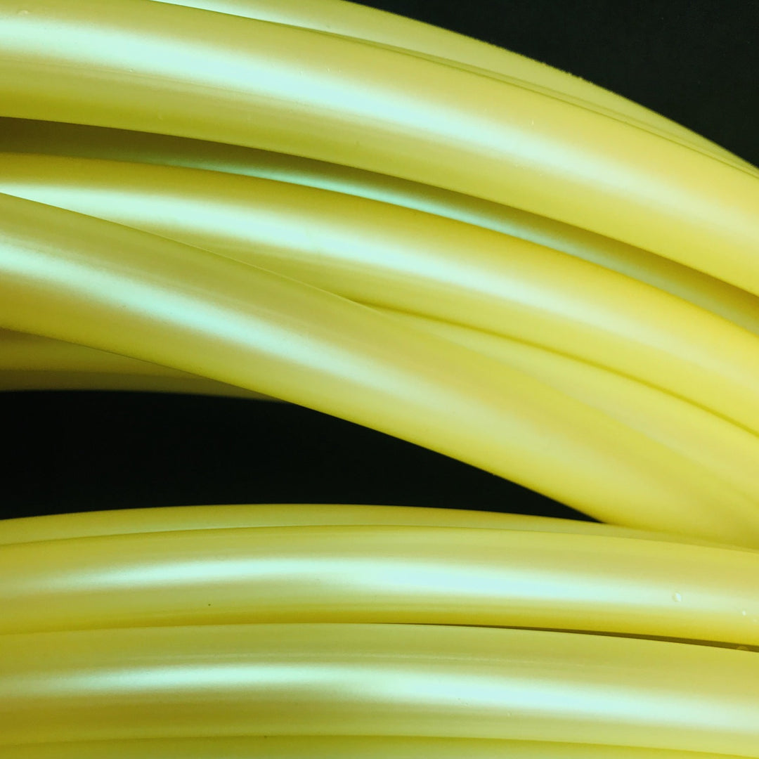 Lemon yellow hula hoops. Coils of fitness hula hoops in Lemon lime