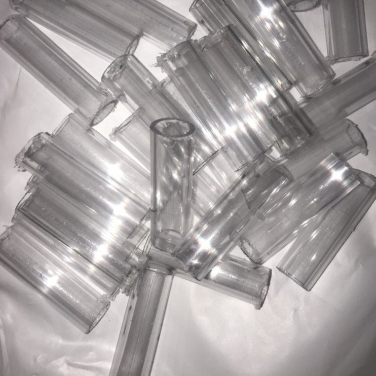 pile of clear Small polycarbonate connectors for joining hula hoop tubing