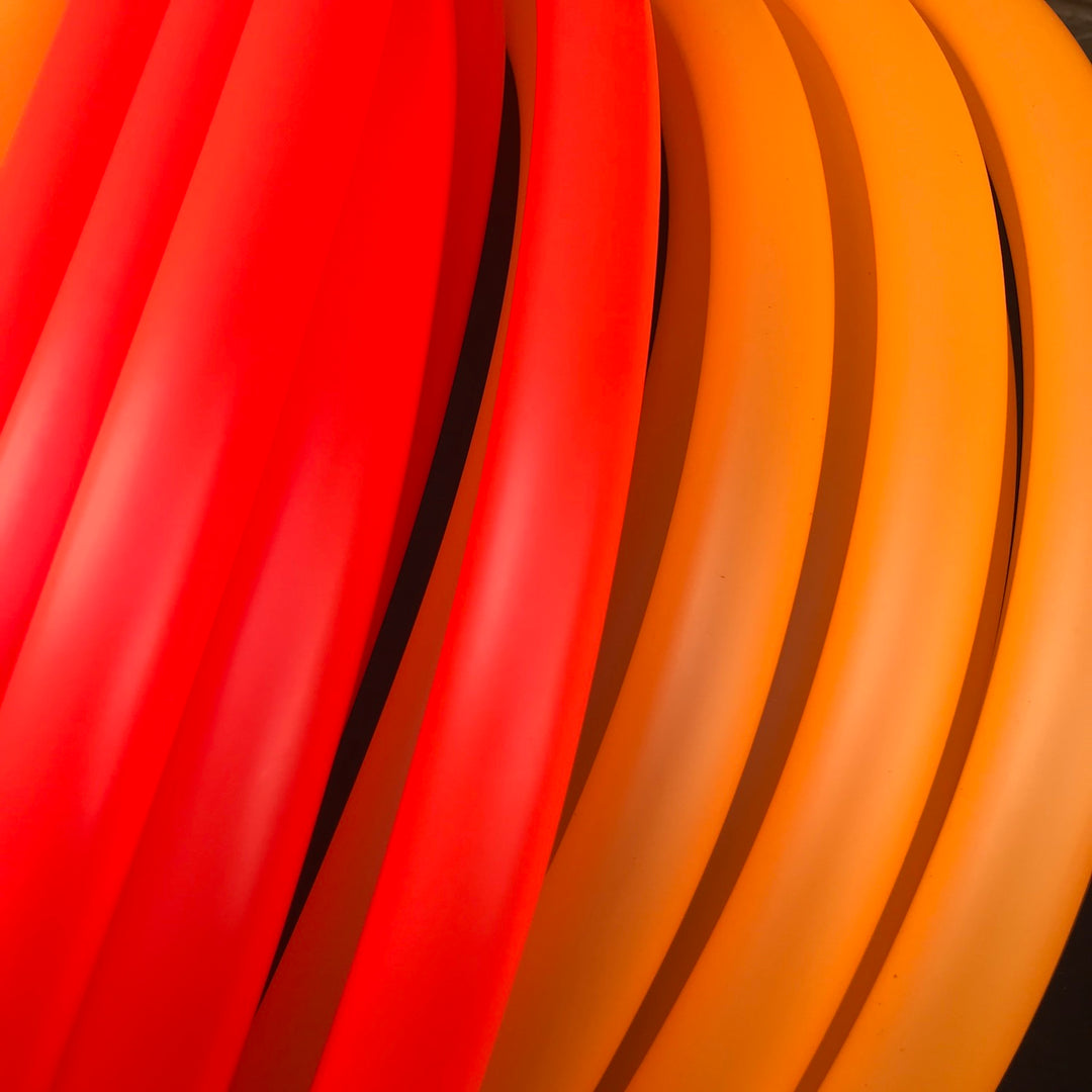 Polypro hoop coils UV red/fire beside translucent UV Orange