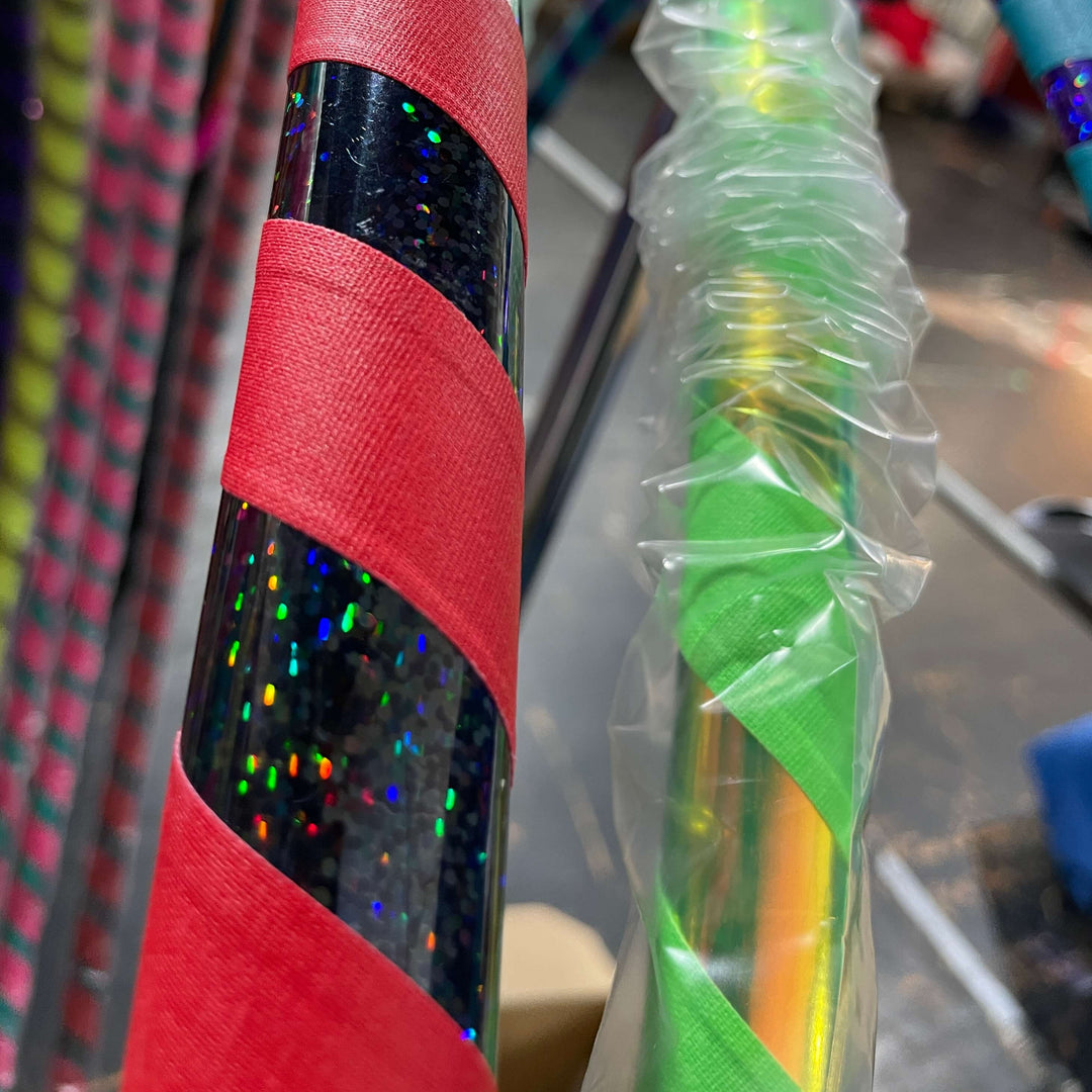 Adult beginner hula hoop taped in shiny black holographic tape and red grip tape 