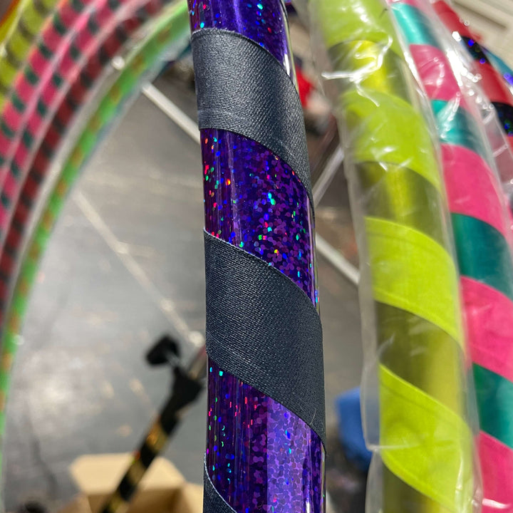 Adult beginner hula hoop taped in shiny purple holographic tape and navy grip tape 