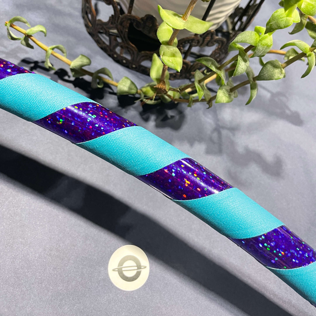 Adult beginner hula hoop taped in shiny purple and teal grip tape 