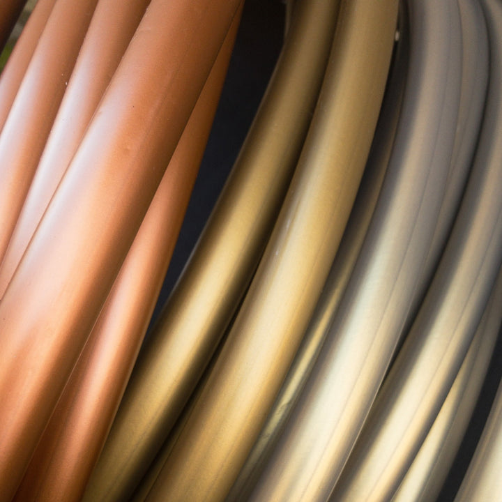 Champagne gold, copper and Cryptic egyptian polypro tubing. Metal gold hoop, pale metallic purple. Stacked hoop coils