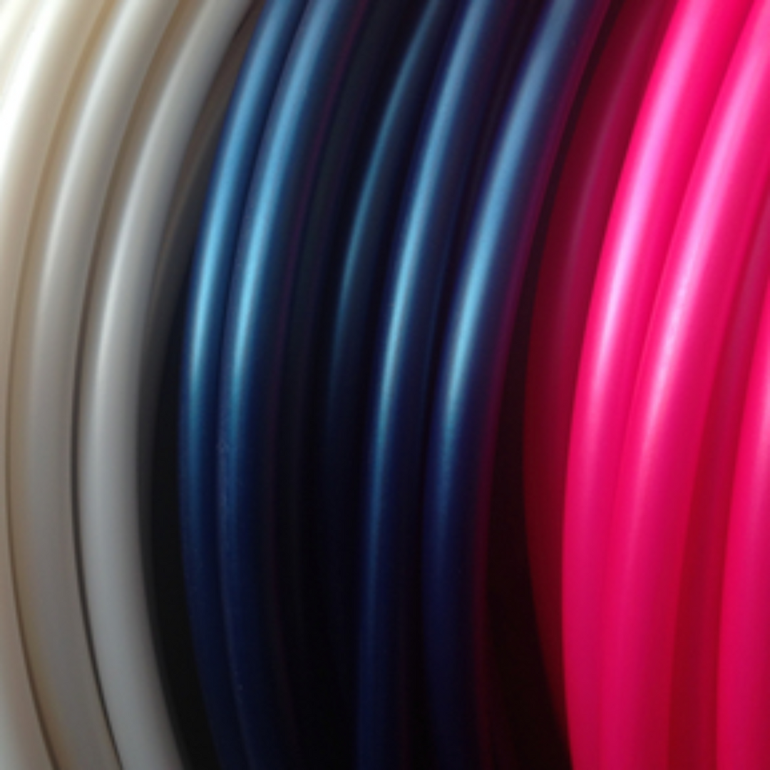 Coils of hoop tubing in white, navy and valentina pink stacked left to right